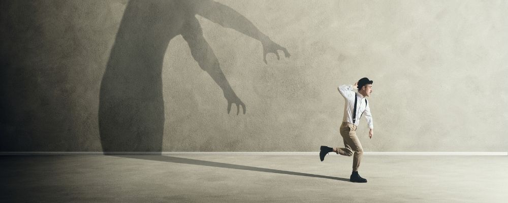 Man running from his own big shadow