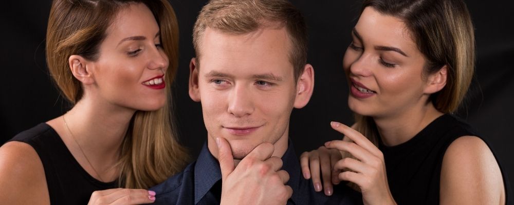 Narcissist man with two women around him who give him attention